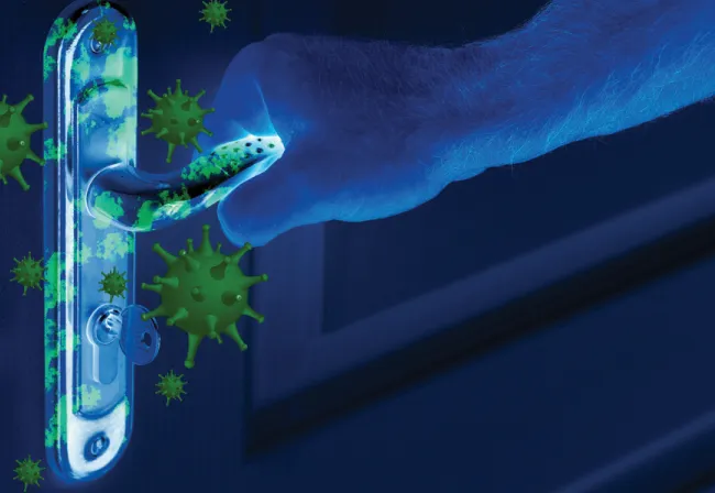 A hand reaching for a door handle, with pathogens highlighted to illustrate a common cross-contamination touchpoint
